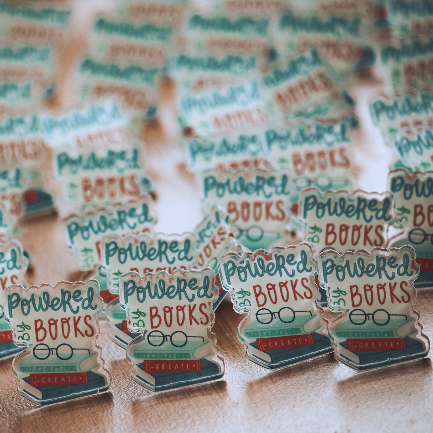 Powered by books l acrylic pins